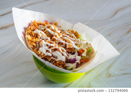 Spicy shawarma shredded chicken with vegetables, Delicious bowl of seasoned chicken and fresh vegetables, Vibrant and savory chicken dish piled high with vegetables and crispy 132794066
