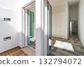 Stylish entrance with reflective surfaces, Sophisticated hallway featuring glass and modern materials, Elegant entryway showcasing bright lighting and polished decor 132794072