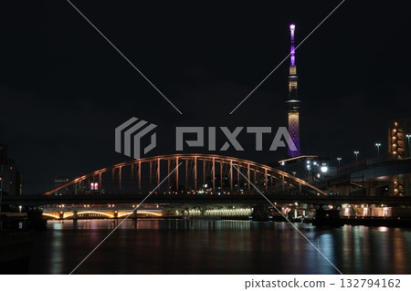 The Sobu Line Sumida River Bridge shining over the Sumida River (also the Skytree) 132794162
