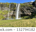 A beautiful rainbow and a view of Seljalandsfoss, a waterfall in southern Iceland. 132794182