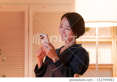 Young woman looking at a smartphone at night Young woman looking at a smartphone at night 132794961