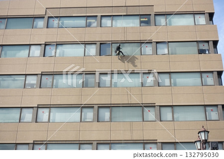 Workers cleaning windows in a high-rise building 132795030