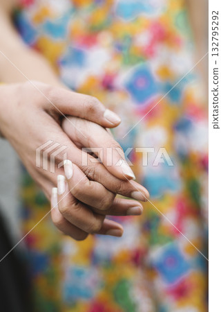 Closeup of couple holding hands affectionately Closeup of couple holding hands affectionately 132795292