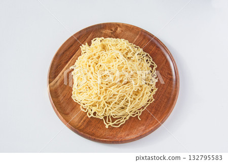 Thin, curly Chinese noodles served on a plate Thin, curly Chinese noodles served on a plate 132795583