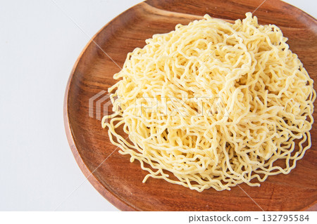 Thin, curly Chinese noodles served on a plate Thin, curly Chinese noodles served on a plate 132795584