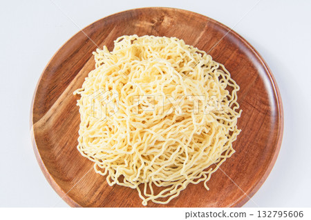 Thin, curly Chinese noodles served on a plate Thin, curly Chinese noodles served on a plate 132795606