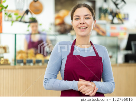 Friendly cafe employee invites you to visit establishment 132796016