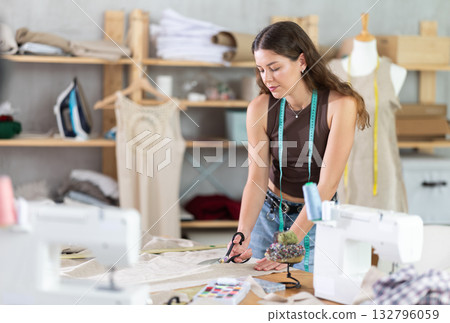 Woman tailor cutting fabric on table Woman tailor cutting fabric on table 132796059