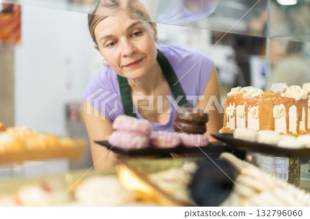 Adult woman waitress offers fresh donuts 132796060