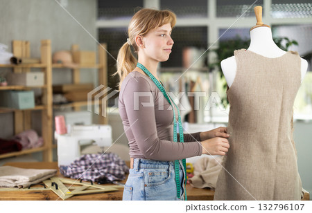 Dressmaker woman checking a sewn dress 132796107