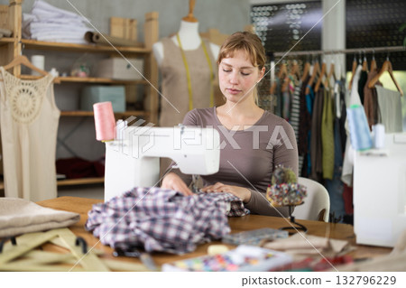 Woman tailor working at sewing machine Woman tailor working at sewing machine 132796229