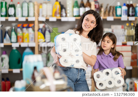 Woman with daughter choosing toilet paper in store 132796300