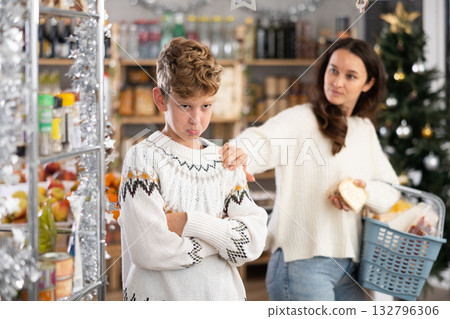 Mom scolds teenage son for bad behavior in grocery supermarket 132796306