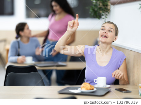 Adult woman calls waiter in cafe 132796319