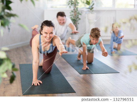 Preteen children practice yoga and Pilates with parents Preteen children practice yoga and Pilates with parents 132796551