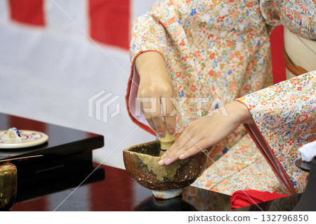 A woman putting tea 132796850