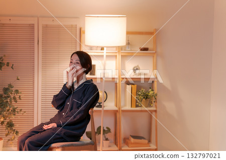 A woman relaxing in a chair at night 132797021