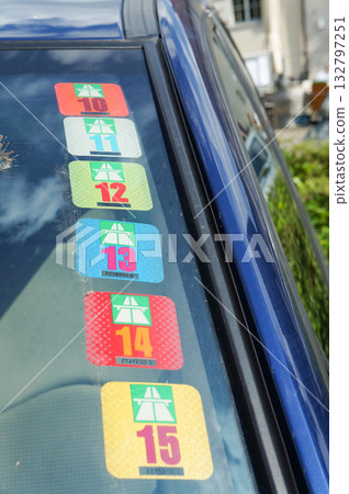 The annual vehicle inspection certificate attached to the corner of the car's windshield The annual vehicle inspection certificate attached to the corner of the car's windshield 132797251