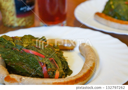 A healthy German home-cooked meal with plenty of vegetables and long sausages 132797262