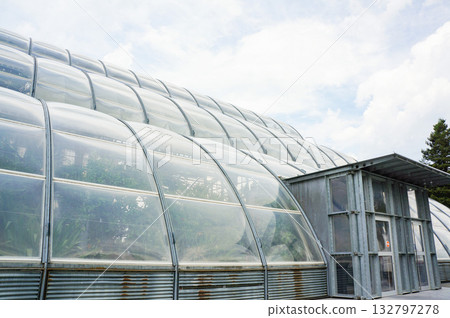 The exterior of the greenhouse, which is well-controlled under a cloudy sky The exterior of the greenhouse, which is well-controlled under a cloudy sky 132797278