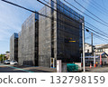 An apartment building covered in black netting due to exterior wall construction An apartment building covered in black netting due to exterior wall construction 132798159