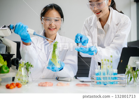 Food scientists in lab coats, testing samples, and analyzing food safety and quality 132801713