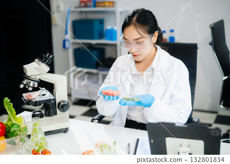 Food scientists in lab coats, testing samples, and analyzing food safety and quality 132801834