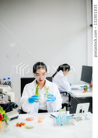 Food scientists in lab coats, testing samples, and analyzing food safety and quality Food scientists in lab coats, testing samples, and analyzing food safety and quality 132801835