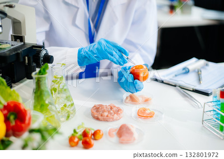 Food scientists in lab coats, testing samples, and analyzing food safety and quality 132801972
