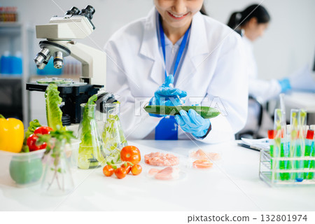 Food scientists in lab coats, testing samples, and analyzing food safety and quality 132801974