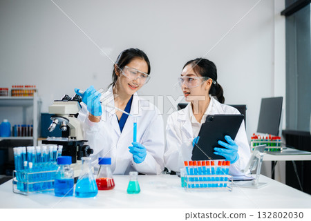 Female Scientists Conducting Chemistry Research in Modern Laboratory Female Scientists Conducting Chemistry Research in Modern Laboratory 132802030