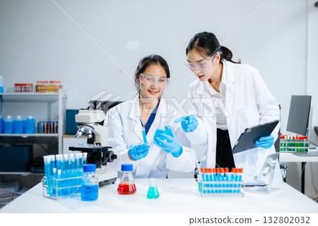 Female Scientists Conducting Chemistry Research in Modern Laboratory Female Scientists Conducting Chemistry Research in Modern Laboratory 132802032