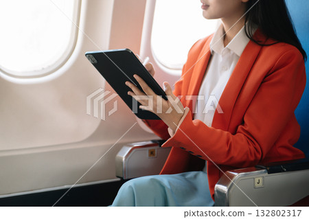 Business woman sitting front tablet ,laptop computer with financial graphs and statistics on monitor Business woman sitting front tablet ,laptop computer with financial graphs and statistics on monitor 132802317