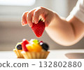 Child hand reaching strawberry fruit 132802880