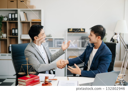 Asian business team and lawyers discussing contract papers sitting at the table. Concepts of law, advice, legal services. Asian business team and lawyers discussing contract papers sitting at the table. Concepts of law, advice, legal services. 132802946