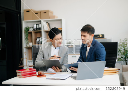 Asian business team and lawyers discussing contract papers sitting at the table. Concepts of law, advice, legal services. Asian business team and lawyers discussing contract papers sitting at the table. Concepts of law, advice, legal services. 132802949