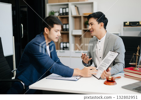 Asian business team and lawyers discussing contract papers sitting at the table. Concepts of law, advice, legal services. Asian business team and lawyers discussing contract papers sitting at the table. Concepts of law, advice, legal services. 132802951