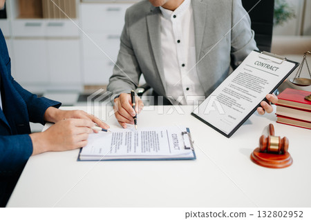 Asian business team and lawyers discussing contract papers sitting at the table. Concepts of law, advice, legal services. 132802952