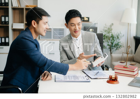 Asian business team and lawyers discussing contract papers sitting at the table. Concepts of law, advice, legal services. Asian business team and lawyers discussing contract papers sitting at the table. Concepts of law, advice, legal services. 132802982