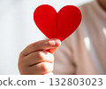 Cinematic hand holding red heart symbol background 132803023