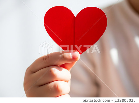 Cinematic hand holding red heart symbol background Cinematic hand holding red heart symbol background 132803023