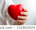 Close up hand holding red heart shape 132803024