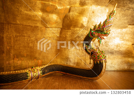 Naga statue situated in a cave at Wat Ahong Silawat temple in Bueng Kan province, Thailand. A naga statue is mythical creature that symbolizes protection, water in Southeast Asian country. Naga statue situated in a cave at Wat Ahong Silawat temple in Bueng Kan province, Thailand. A naga statue is mythical creature that symbolizes protection, water in Southeast Asian country. 132803458