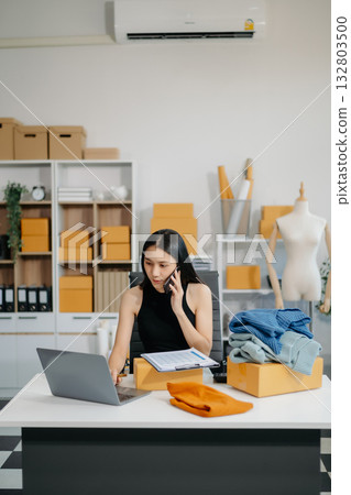 Small business entrepreneur SME woman working at home office, BOX,tablet and laptop online, marketing, packaging, delivery 132803500