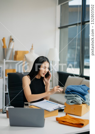 Small business entrepreneur SME woman working at home office, BOX,tablet and laptop online, marketing, packaging, delivery 132803502