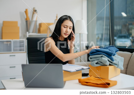 Small business entrepreneur SME woman working at home office, BOX,tablet and laptop online, marketing, packaging, delivery 132803503