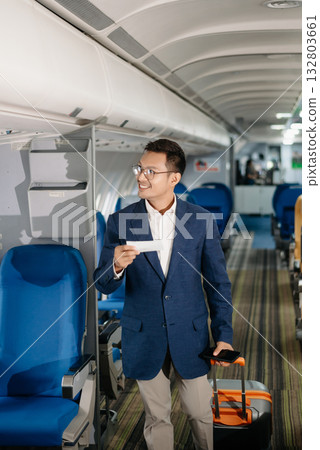 Young Asian executive excels in first class, multitasking with digital tablet, laptop and smartphone. Travel in style, Young Asian executive excels in first class, multitasking with digital tablet, laptop and smartphone. Travel in style, 132803661