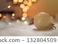 Clean christmas bauble on white wool with bokeh lights background 132804509