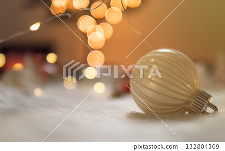 Clean christmas bauble on white wool with bokeh lights background 132804509