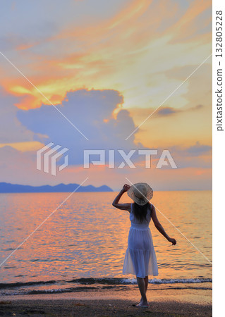 Sunset over the sea and a woman 132805228